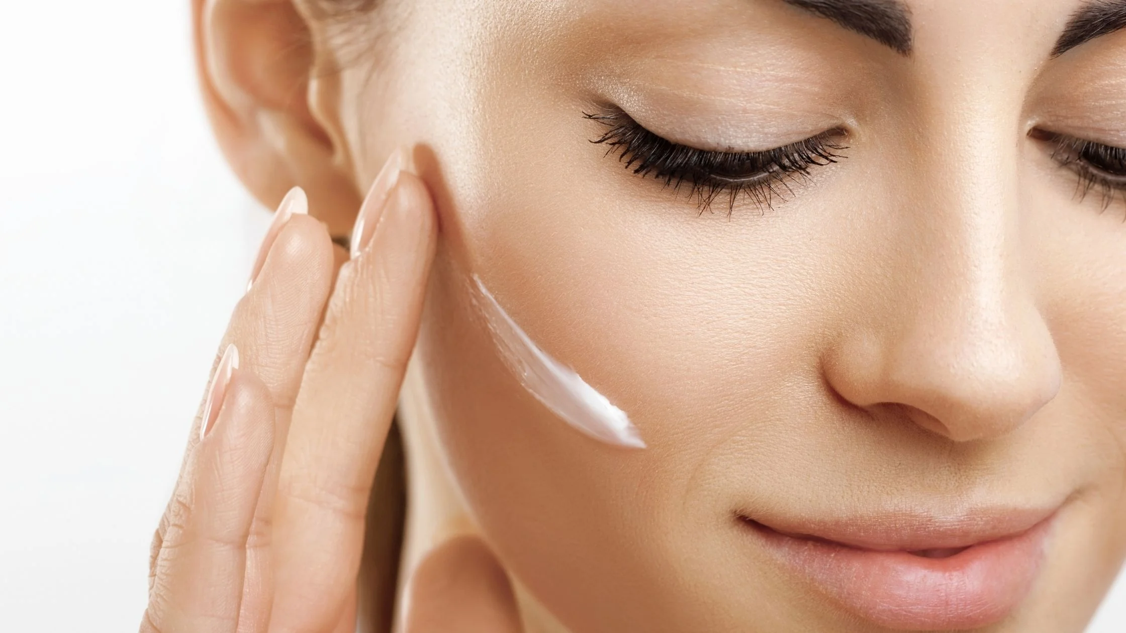 women moisturising her face